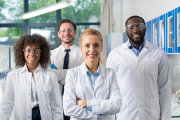 Smiling Group Of Scientists In Modern Laboratory With Female Leader, Mix Race Team Of Scientific...