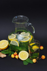 Water detox in a glass jar and a glass. Fresh green mint and berries. A refreshing and healthy drink. Copy space.