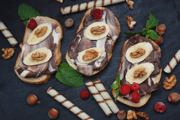 Sandwich for children at school. Chopsticks with chocolate and fruit.