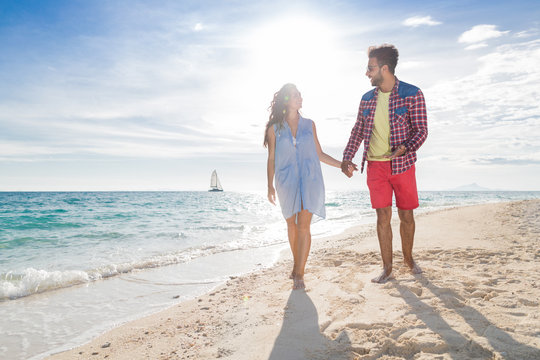 Young Couple On Beach Summer Vacation, Happy Smiling Man And Woman Walking Seaside Sea Ocean Holiday Travel