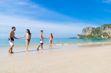 Two Couple On Beach Summer Vacation, Young People In Love Walking, Man Woman Holding Hands Sea Ocean Holiday Travel