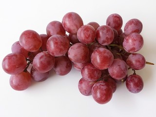Bunch of red grapes on white background, closeup
