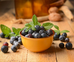pile of blueberries in the terracotta bowl