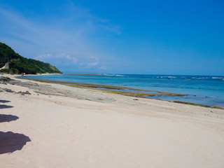 Fototapeta na wymiar Beautiful sunny day and white sand in the beach of Pantai pandawa, in Bali island, Indonesia