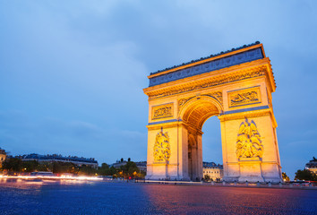Fototapeta na wymiar Illuminated Arc de Triomphe in Paris, France
