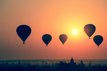 Fototapeta na wymiar Silhouette of hot air balloon over Bagan at sunrise in misty morning, Myanmar
