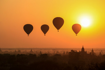 Silhouette of hot air balloon over Bagan at sunrise in misty morning, Myanmar