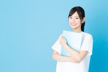 Obraz premium portrait of asian nurse isolated on blue background