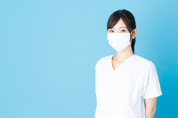portrait of asian nurse isolated on blue background