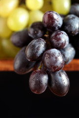Black and white grape white water drops on the black background