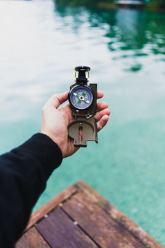 Crop male hand holding compass