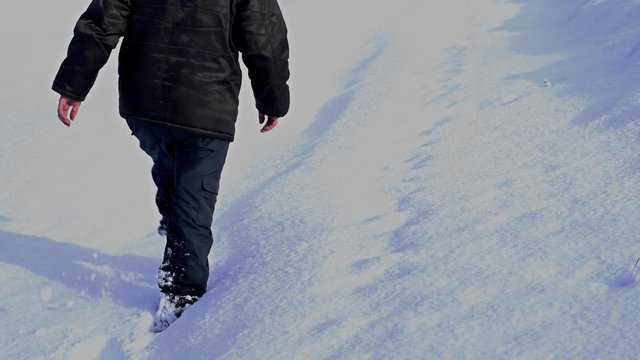 Man walking in deep snow - (4K)