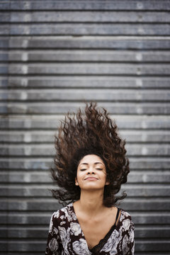 Happy Young Woman Throwing Her Hair Back
