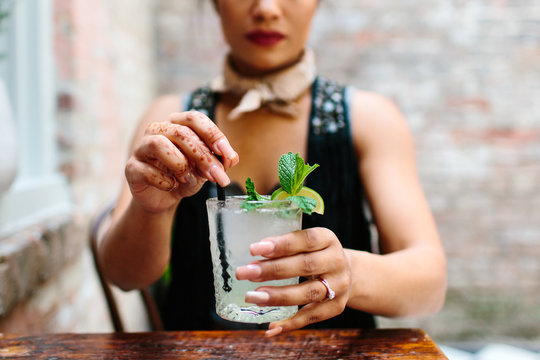 A woman drinking a refreshing mojito
