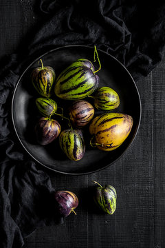 Pear-melons on a black wooden table