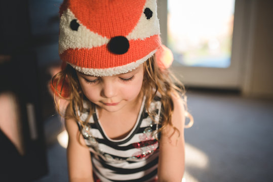 Girl looking down in fox hat