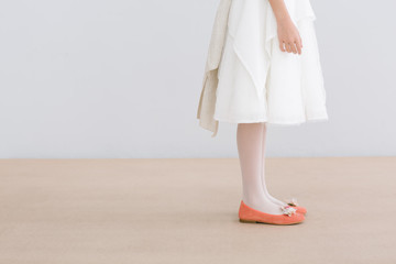 Young female with white dress and orange shoes