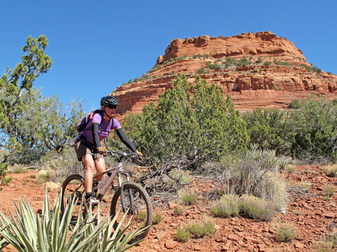 Woman Mountain Biking In The Red Rocks, Sedona, Arizona, USA