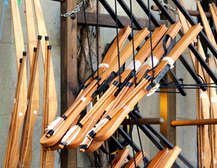 Toy archery bows and arrows for sale outside a traditional toy shop