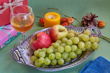 Glasses of wine and grapes on yellow background