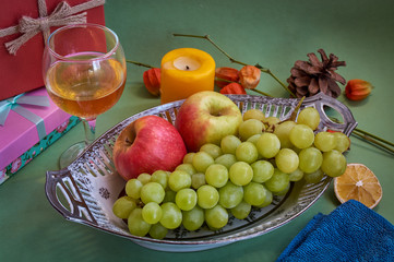 Glasses of wine and grapes on yellow background