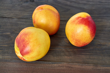 Fresh peaches on wooden background