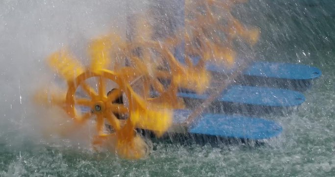 Rotating Paddle Wheels at Water in Aquaculture Pond