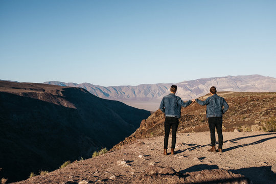 Two men in similar dress in nature together