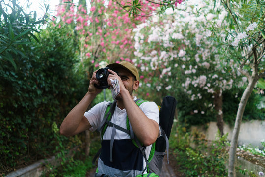 Man taking photo of surroundings in city