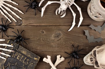 Halloween frame of black and white decor over a rustic old wood background