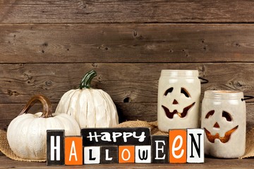 Wooden Happy Halloween sign with rustic white decor against an old wood background