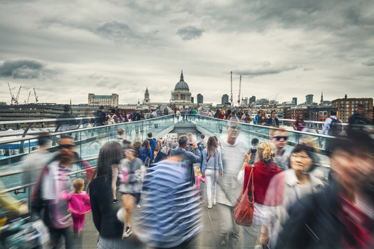 People in Motion On Millennium Bridge in London City, UK