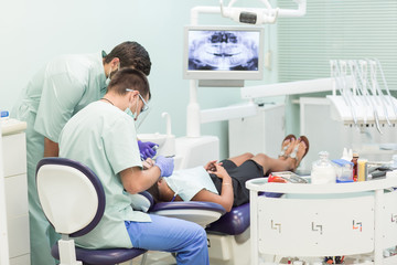 Fototapeta premium Doctor Dentist with an assistant work in a dental clinic.
