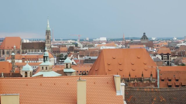 NUREMBERG, GERMANY August 14, 2017: Church and old town with cloudy sky by day timelapse, zoom out - a view on the old town nuremberg with red roofs and St. Sebald church