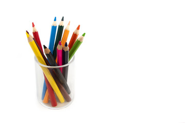 Colorful pencil in a glass on white background