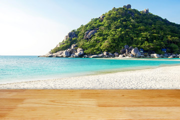 Wooden floor with white sand beach island and blur mountain hill background landscape