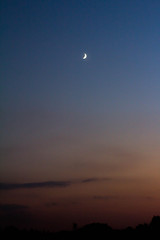 The Full Moon in daylight blue sky