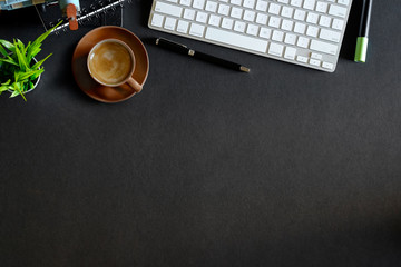 Work space concept : Office dark desk table with computer and supplies. Top view with copy space
