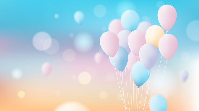 Bunch of colorful pastel balloons flying over bright sky