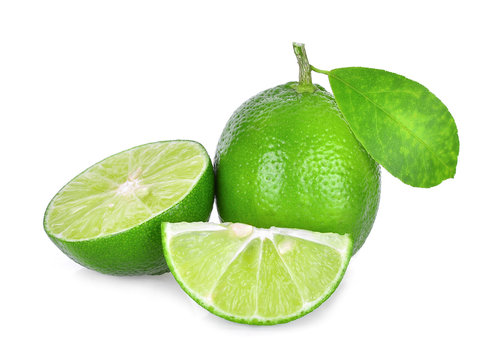 whole and half of fresh green lime with green leaf isolated on white background