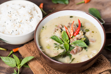 Thai food (Kaeng Khiao Wan),Green curry with pork and cooked rice on wooden background