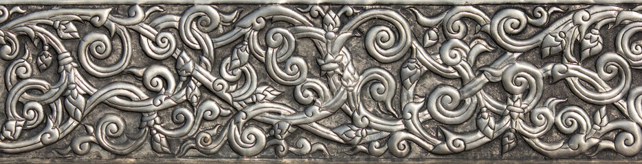 Pattern of silver metal plate with flower carved background, Thai style in temple