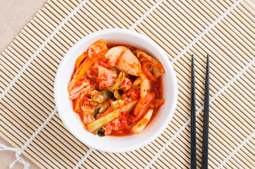 Korean food,kimchi cabbage in a bowl with chopsticks for eating