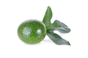 whole fresh passion fruit with leaf on white background
