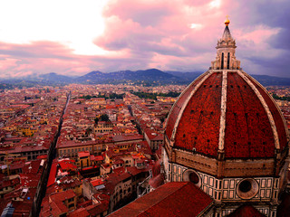 Top view of Duomo and Florence old city in Tuscany, Italy with purple tone cloudy sky and a shade of light from the left