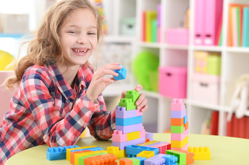girl playing with plastic blocks