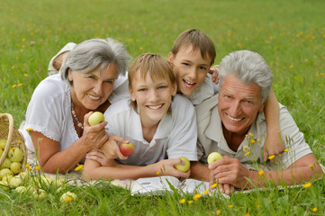 Grandparents with children in park