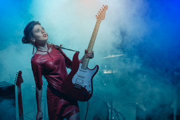 Girl-guitar player plays solo.