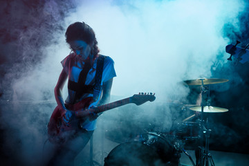 Girl-guitar player plays solo.