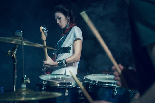 Girl-guitar player plays solo.